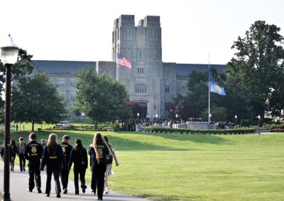 Students in FFA jackets walk across the Virginia Tech Drillfield.