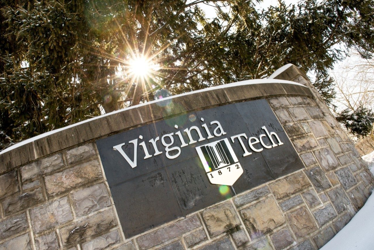 Virginia Tech sign in the snow with solar flare.