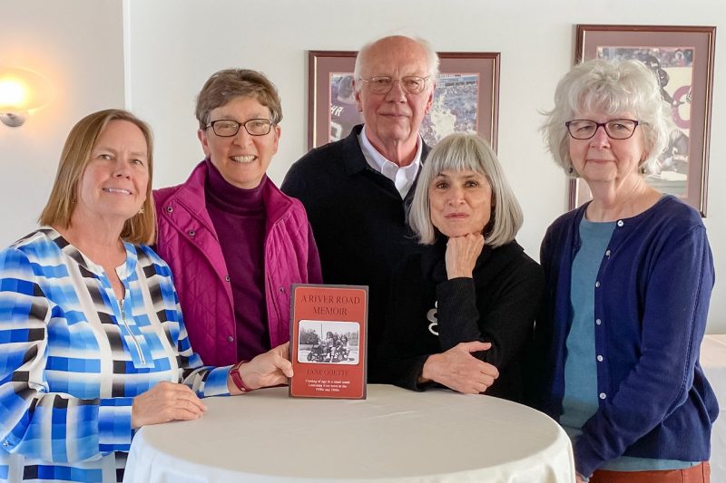 Lifelong Learning Institute Five people gather around a high round table supporting a book.