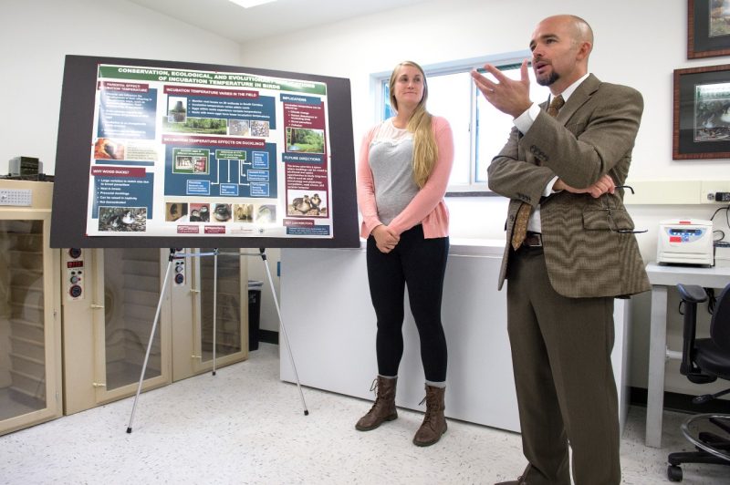 Bill Hopkins  with female student at left speaks at the grand opening of the the Department of Fish and Wildlife Conservation's Research Aviary.