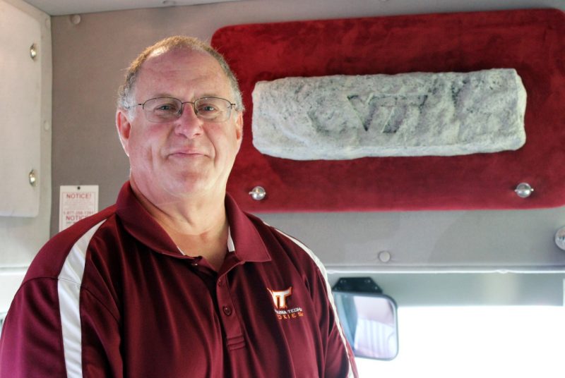 Wilson poses in front of the Hokie Stone engraved with “VT”. 