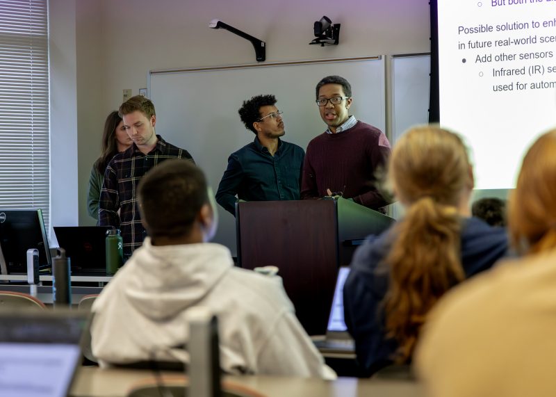 students presenting capstone to a crowd in a classroom