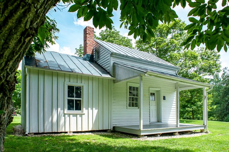 A little white three-room house with a porch.