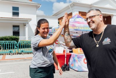 26_20240914_UtProsim_ElliTravis_CF_6955.jpg Elli and a food truck vendor high five.