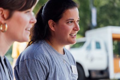 61_20240914_UtProsim_ElliTravis_CF_8336.jpg A close-up of two women talking to an unseen third person.