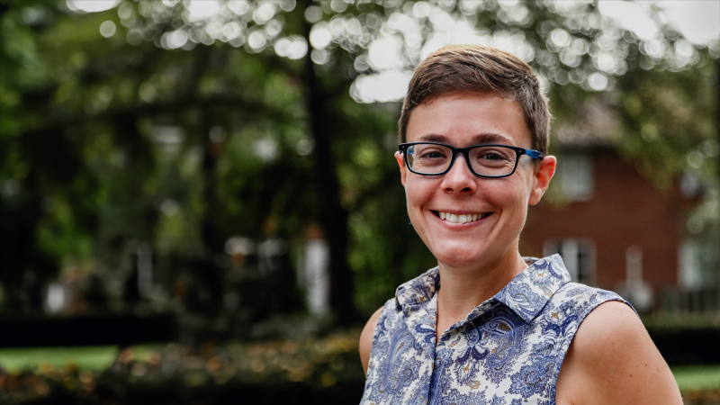 Catherine Cotrupi stands in front of a wooded background.