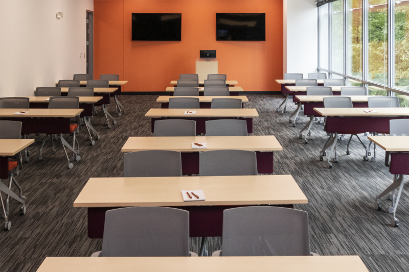 A classroom with one wall made up of floor-to-ceiling windows.