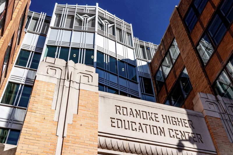 Tall brick and metal building inscribed with Roanoke Higher Education Center on the front. 
