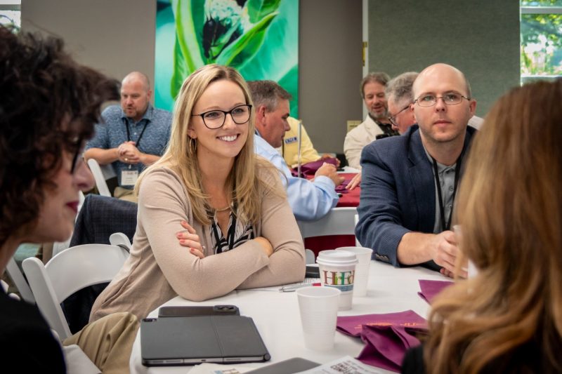 Small Towns Conference Conference attendees talking.