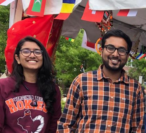 Two students standing under a tent