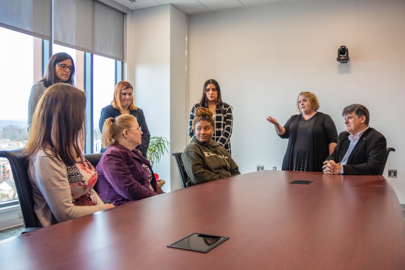 People standing around a conference table